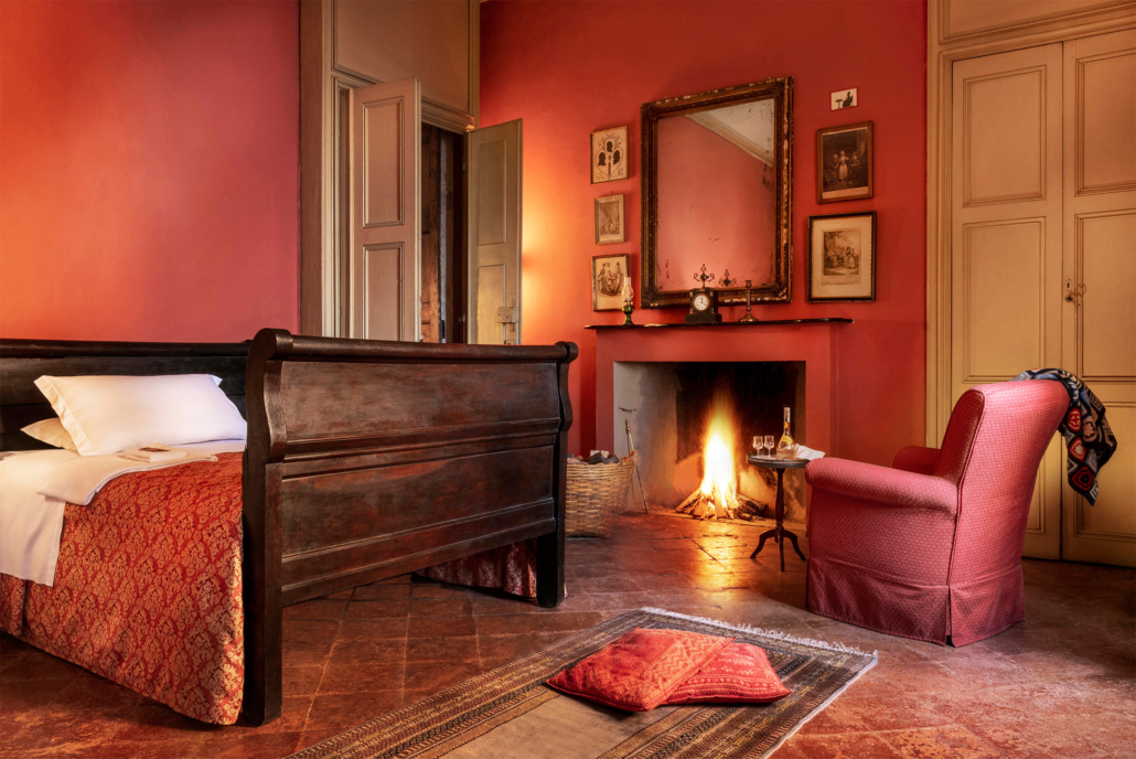 Elegant red-themed bedroom with antique furnishings